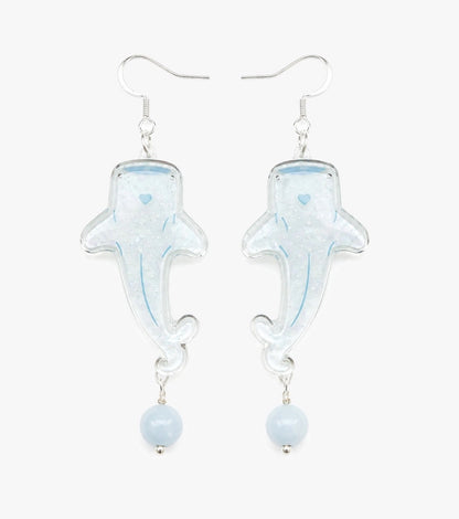 Translucent whale shark drop earrings with pearly texture, soft blue details, and pale blue bead drops.