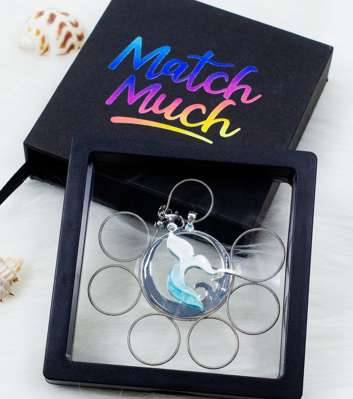 aqua whale tail necklace with translucent white and blue ocean-inspired pendant on a silver-tone chain.