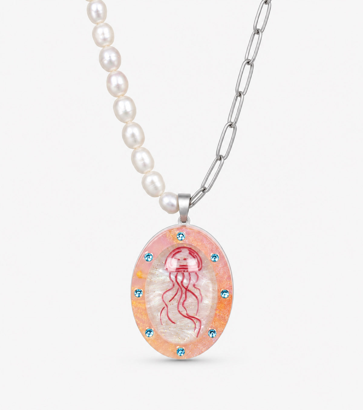 Jellyfish necklace beneath a curved transparent cover with blush pink and blue accents.